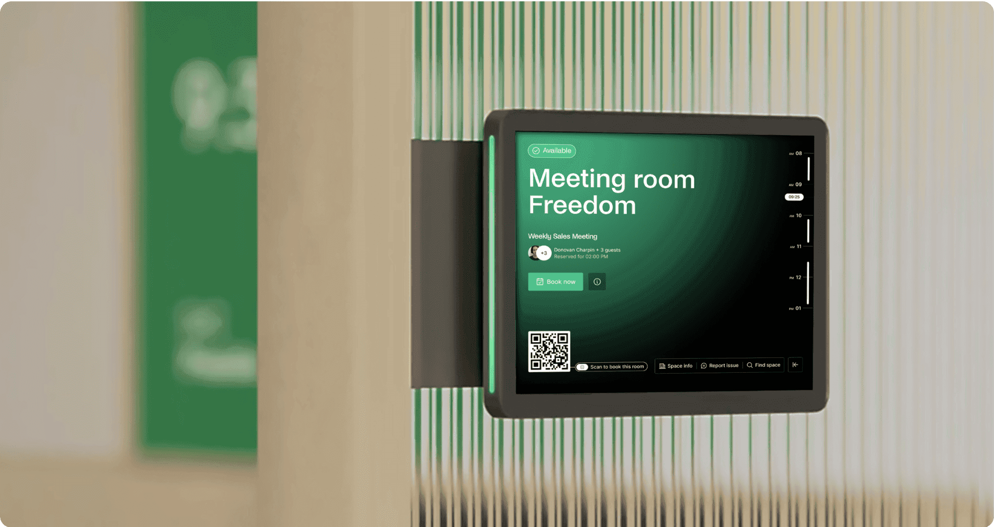Digital screen on a wall showing room availability and a “book now” option via Archie Rooms app.