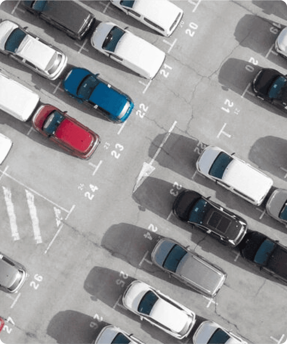 Conference room with a large table and multiple chairs, surrounded by glass walls.